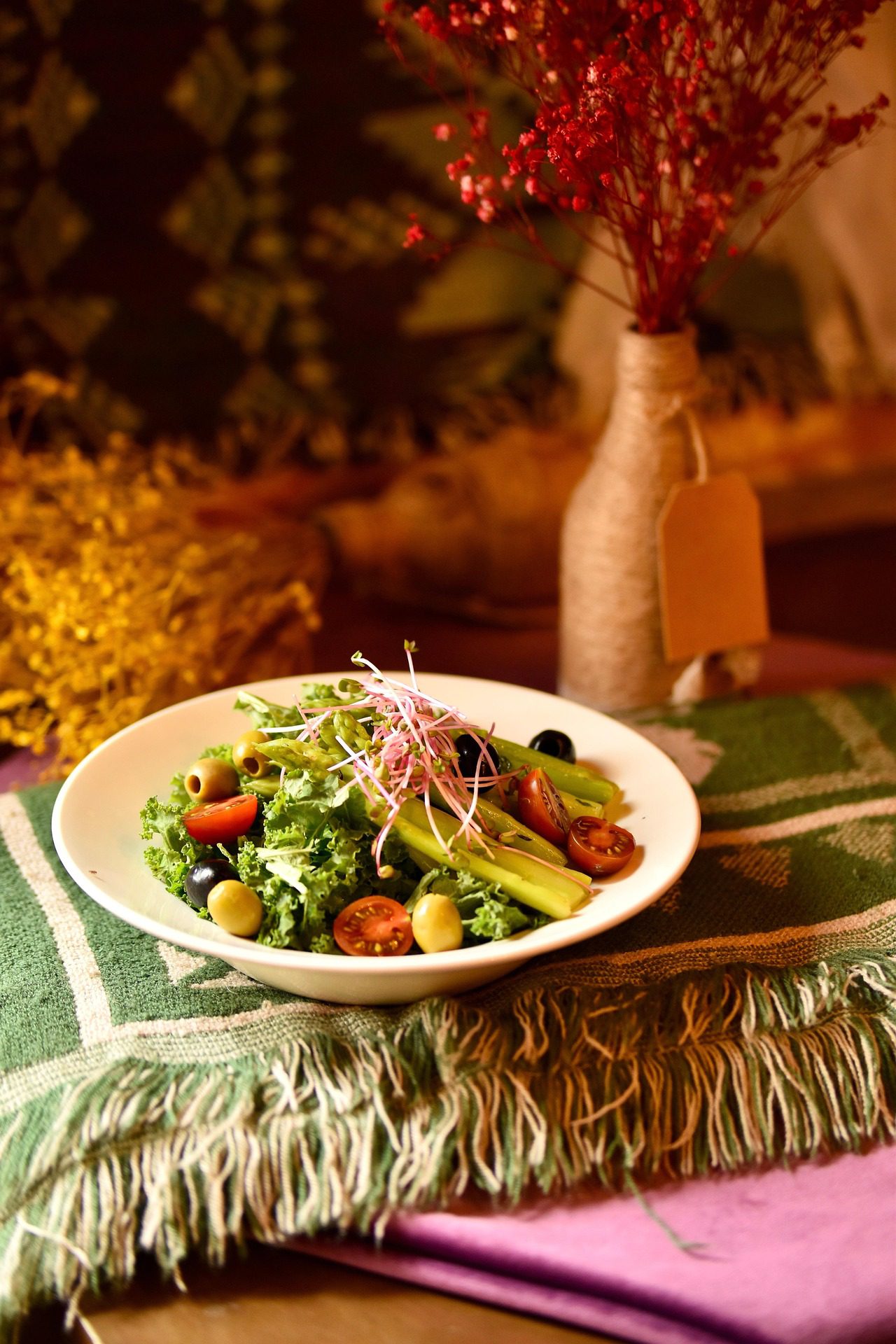 Fresh Mediterranean-style salad with kale, cherry tomatoes, olives, asparagus, and microgreens at Cedar & Stone Bistro in Cowichan Valley.